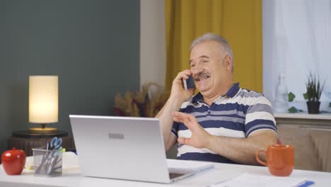 Home-office-worker-old-man-rejoicing-on-the-phone.